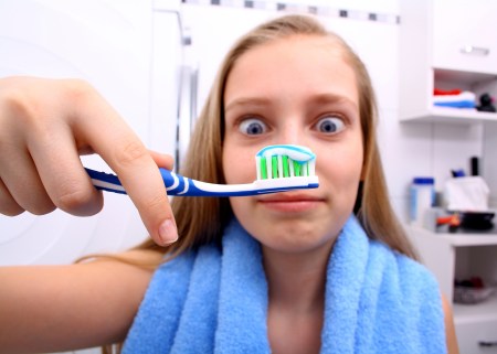 Blonde girl brushing teeth - Special Needs Essentials